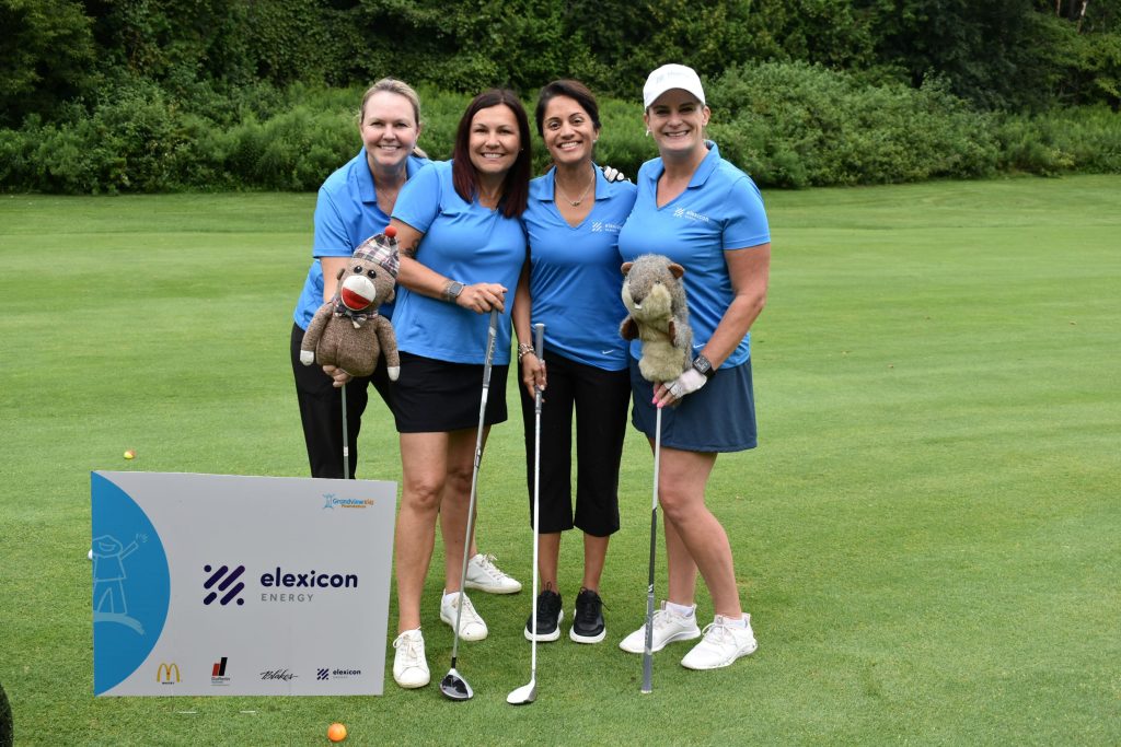 Four Elexicon Energy employees standing at golf course